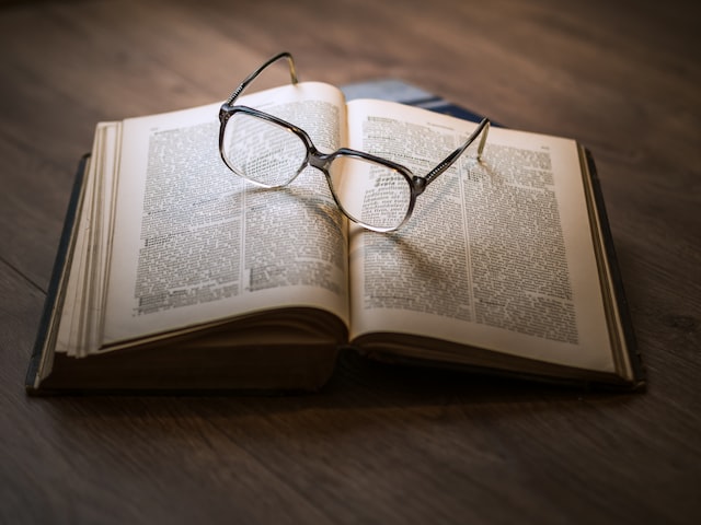 A pair of spectacles on top of an open book