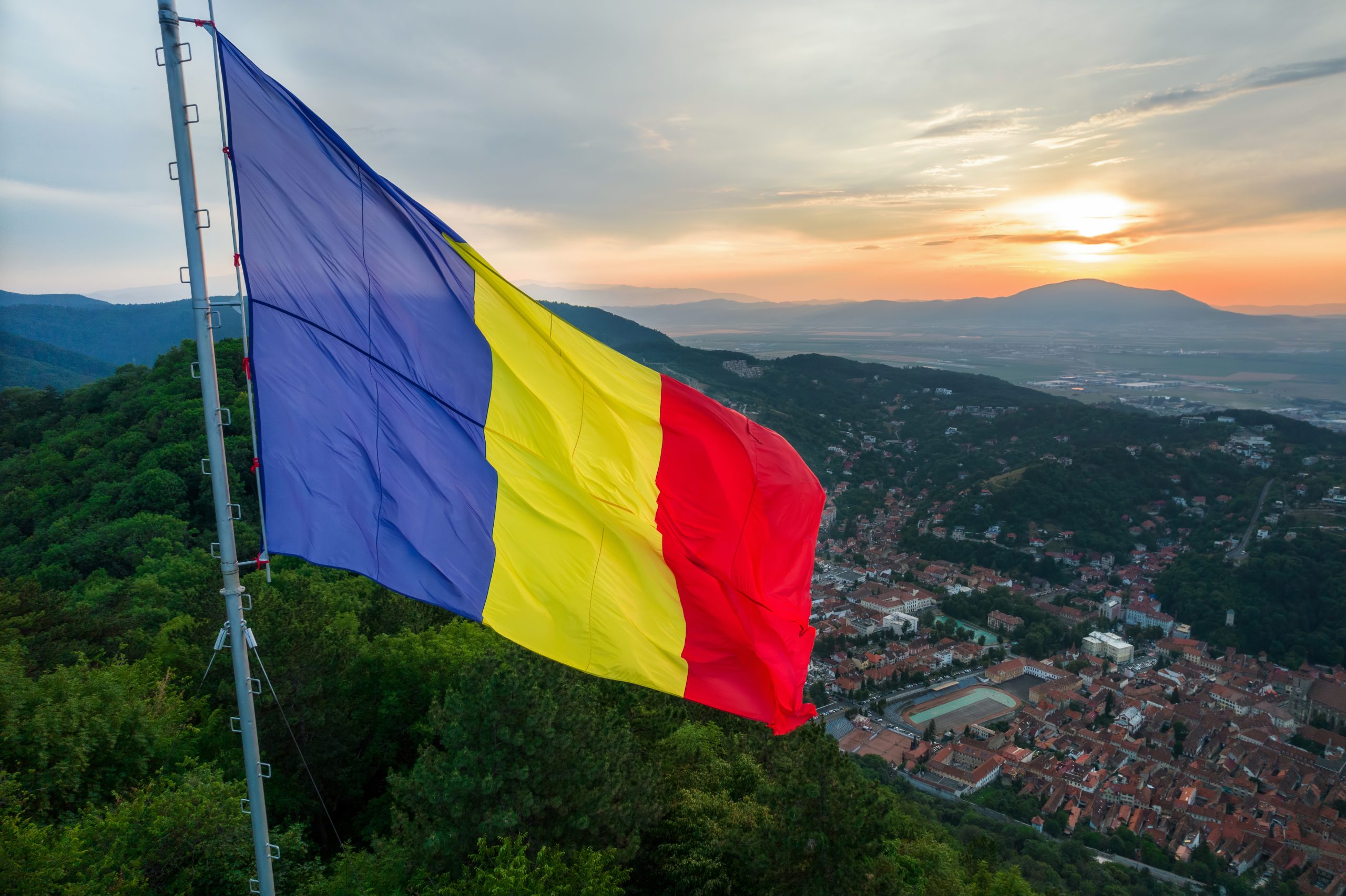 Romanian flag at sunset. Image by frimufilms on Freepik.