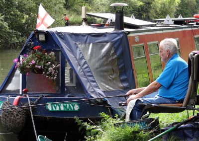 A man fishing in the canal by a narrowboat, image with permission of Richard Jones